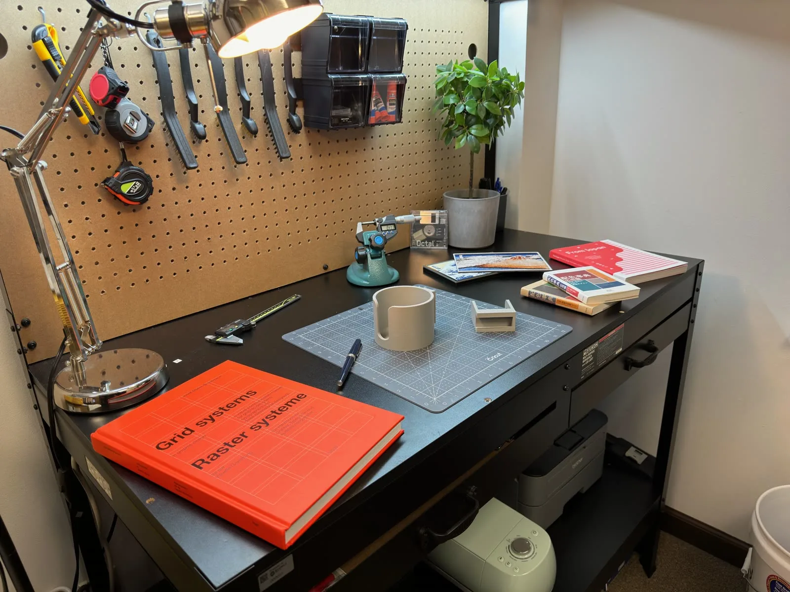 Prototyping workbench at Shibui Tech in Bloomington, Indiana, with calipers, printed parts, and a pegboard of hand tools