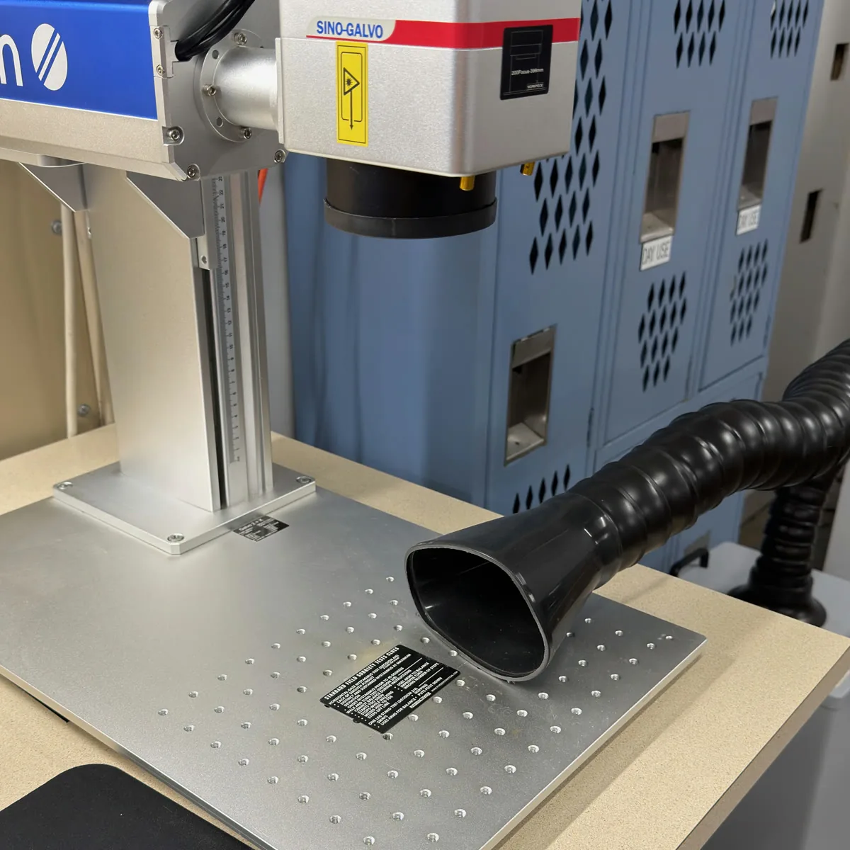Fiber laser engraver marking a stainless steel plate at Shibui Tech in Bloomington, Indiana